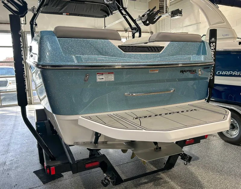 Slide: The Image of Rear view of a 2025 Moomba Max boat in a garage. - 6