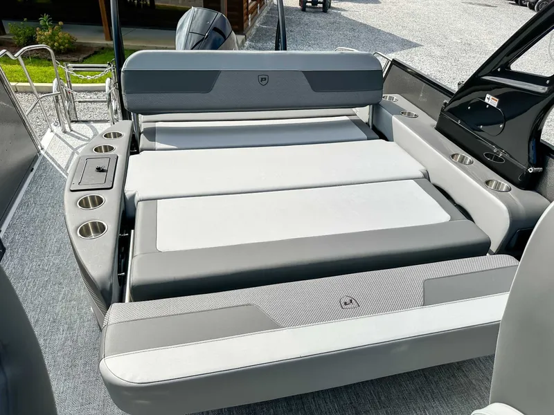 Slide: The Image of 2025 Premier 230 Solaris RL boat with gray upholstery and cup holders. - 15