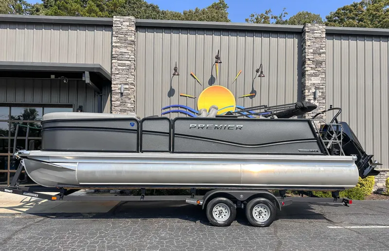 The Image of 2025 Premier 230 Sunsation RL pontoon boat in front of building. - 1