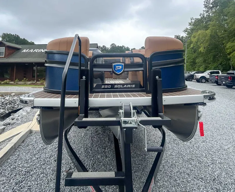 Slide: The Image of 2026 Premier Solaris 230 RL pontoon boat on gravel lot. - 4