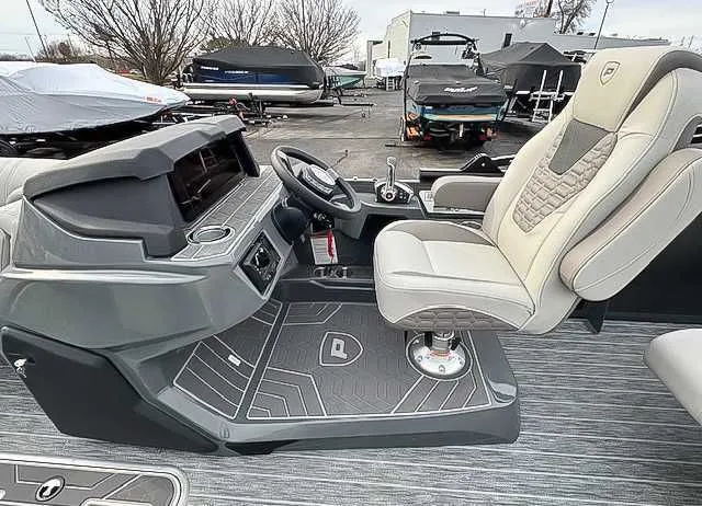 Slide: The Image of Interior of 2026 Premier Intrigue 230 RL boat, featuring modern helm and seat. - 11