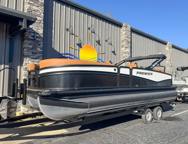 Slide: The Image of 2026 Premier Solaris 230 RF pontoon boat on trailer outside building. - 3
