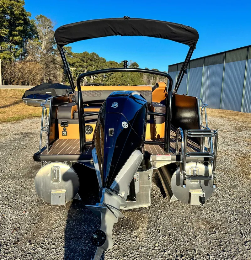 Slide: The Image of 2026 Premier Solaris 250 RL pontoon boat with motor, parked on gravel. - 7
