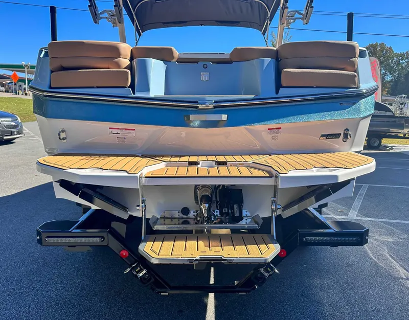 Slide: The Image of Rear view of 2026 MasterCraft XT24 boat with wooden deck. - 10