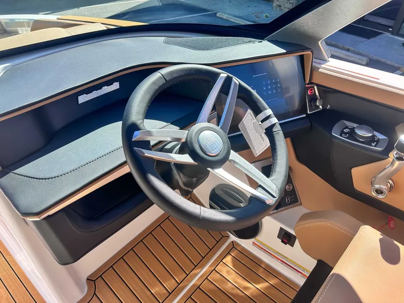 Slide: The Image of Interior of 2026 MasterCraft XT24 with modern steering wheel and dashboard. - 22