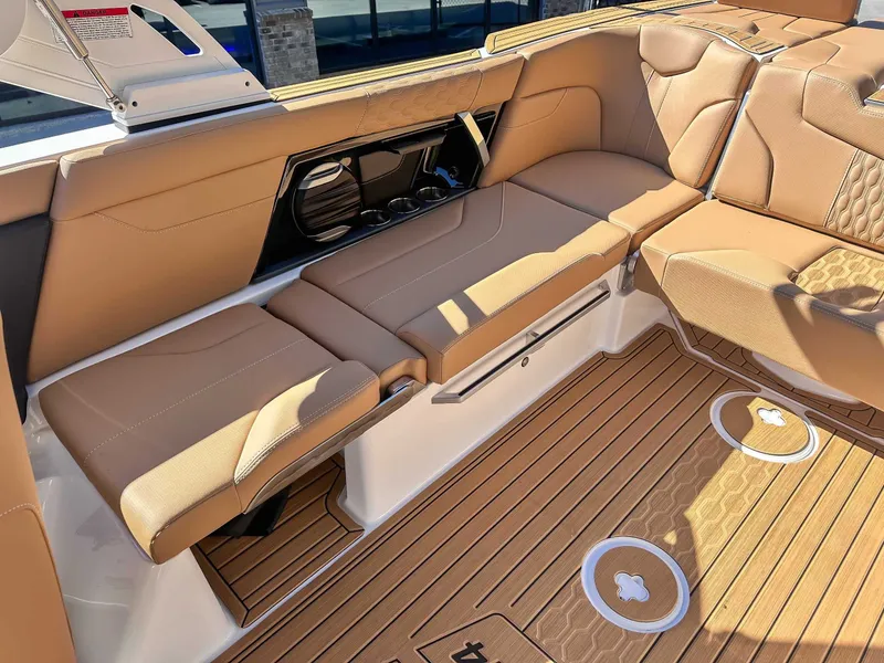 Slide: The Image of Interior of 2026 MasterCraft XT24 with brown leather seating. - 24
