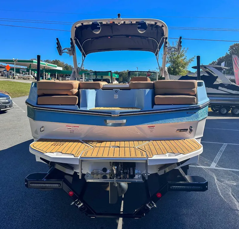 Slide: The Image of Rear view of 2026 MasterCraft XT24 boat on a parking lot. - 9