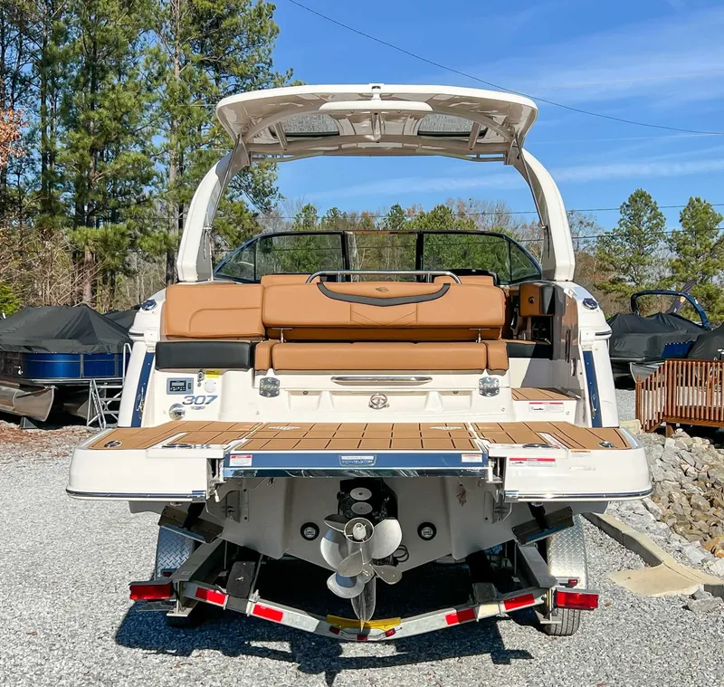 Slide: The Image of Rear view of 2024 Chaparral 307 SSX boat on a trailer. - 11