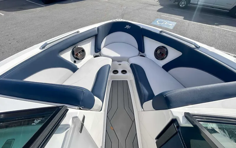 Slide: The Image of Interior of a 2020 MasterCraft XT23 boat with blue and white seating. - 10