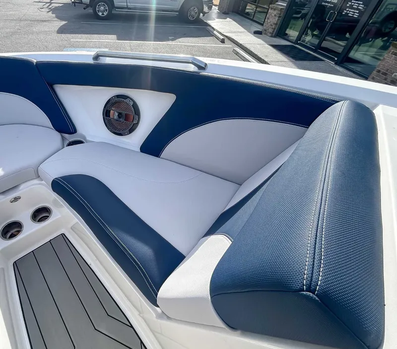 Slide: The Image of Interior of a 2020 MasterCraft XT23 boat with blue and white seating. - 12