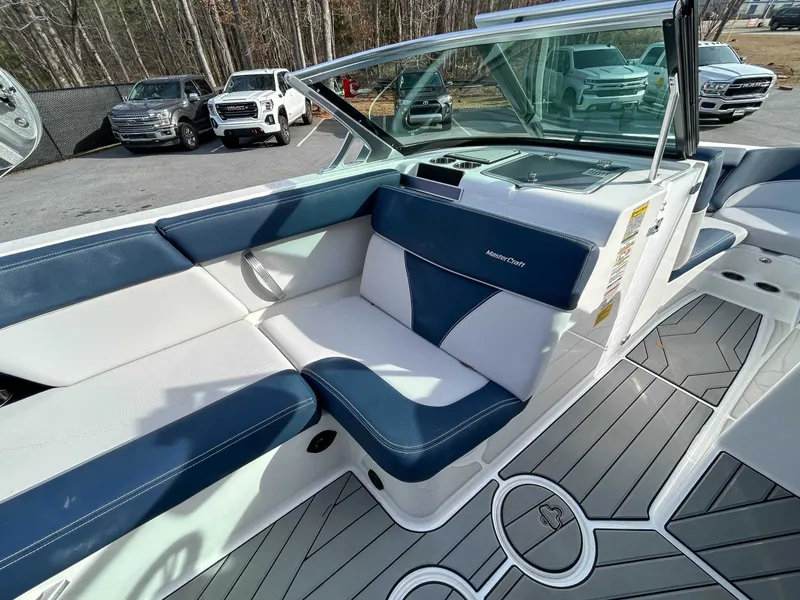 Slide: The Image of Interior of a 2020 MasterCraft XT23 boat with blue and white seating. - 14