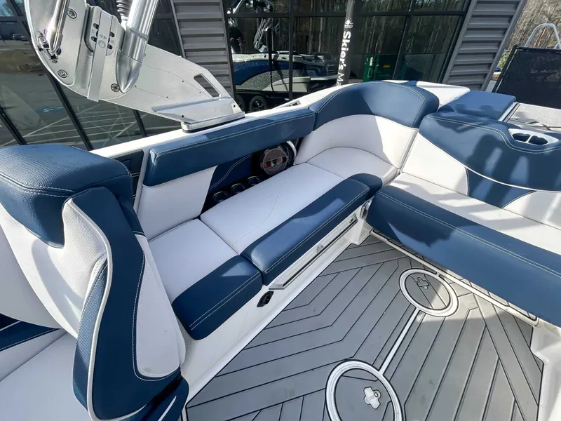 Slide: The Image of Interior of a 2020 MasterCraft XT23 boat with blue and white seating. - 17