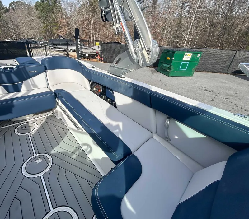 Slide: The Image of Interior of a 2020 MasterCraft XT23 boat with blue and white seating. - 18
