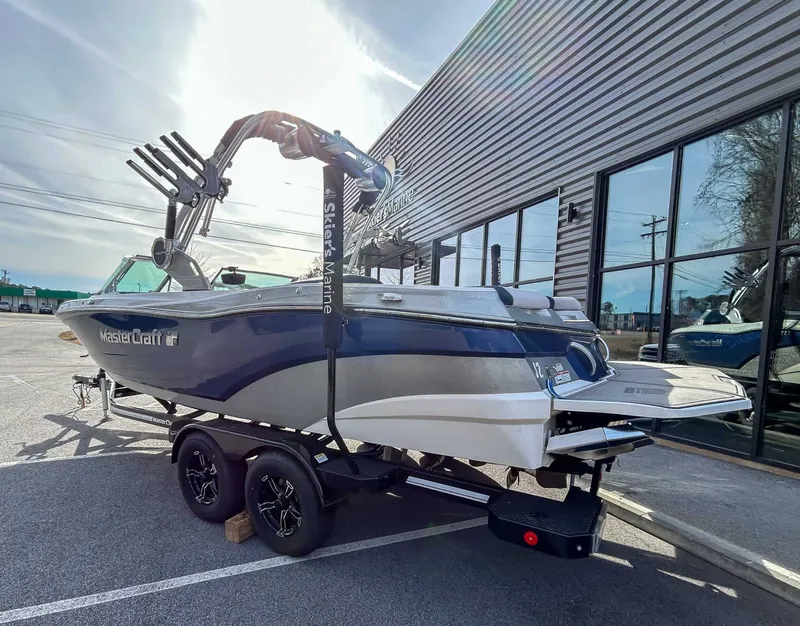 Slide: The Image of 2020 MasterCraft XT23 boat on trailer outside a building. - 6
