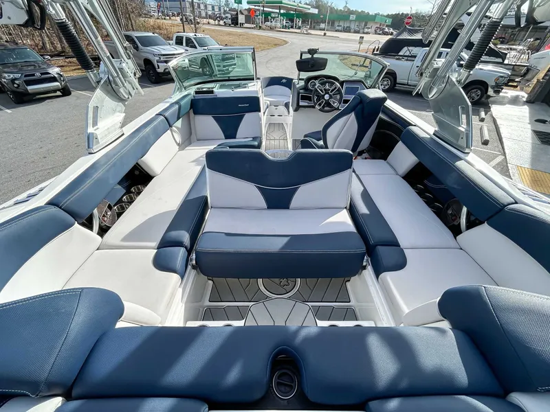 Slide: The Image of Interior of a 2020 MasterCraft XT23 boat with blue and white seating. - 9