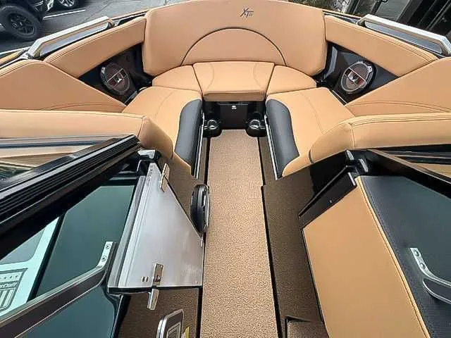 Slide: The Image of Interior of a 2018 MasterCraft XT22 boat with beige seating. - 11