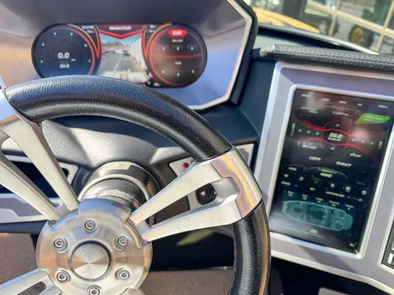 Slide: The Image of Steering wheel and dashboard of a 2018 MasterCraft XT22 boat. - 15