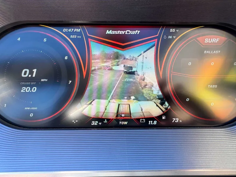 Slide: The Image of 2018 MasterCraft XT22 dashboard with speedometer and rearview camera display. - 16