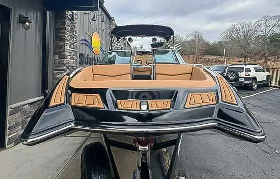 Slide: The Image of 2018 MasterCraft XT22 boat on a trailer outside a building. - 4
