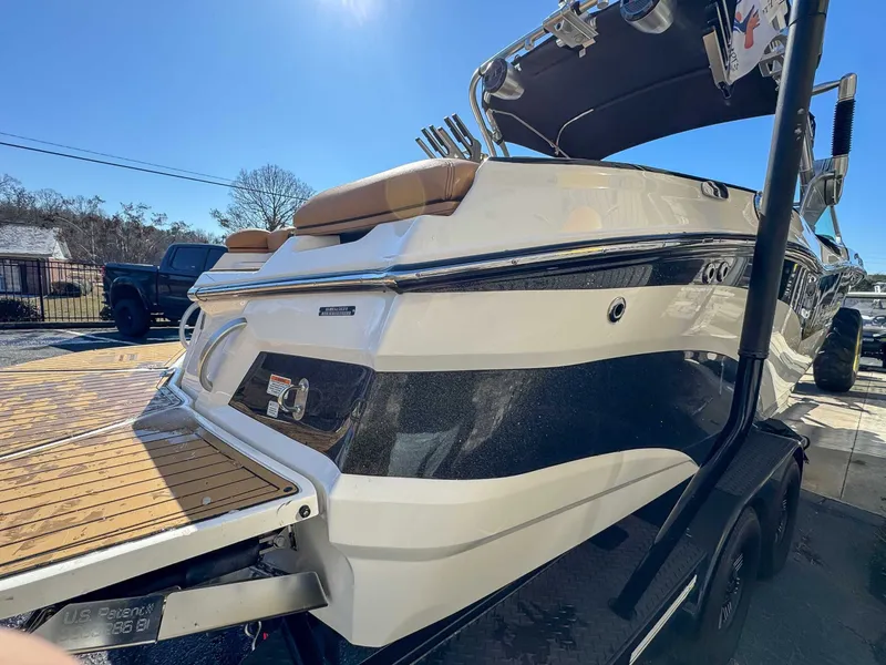 Slide: The Image of 2018 MasterCraft XT22 boat on trailer in sunny weather. - 6