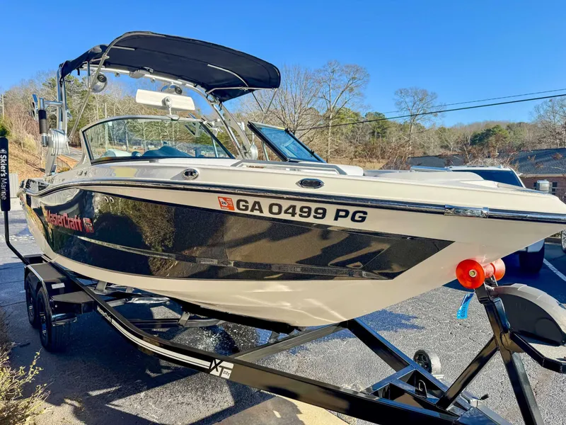 Slide: The Image of 2017 MasterCraft XT21 boat on trailer, sunny day. - 4