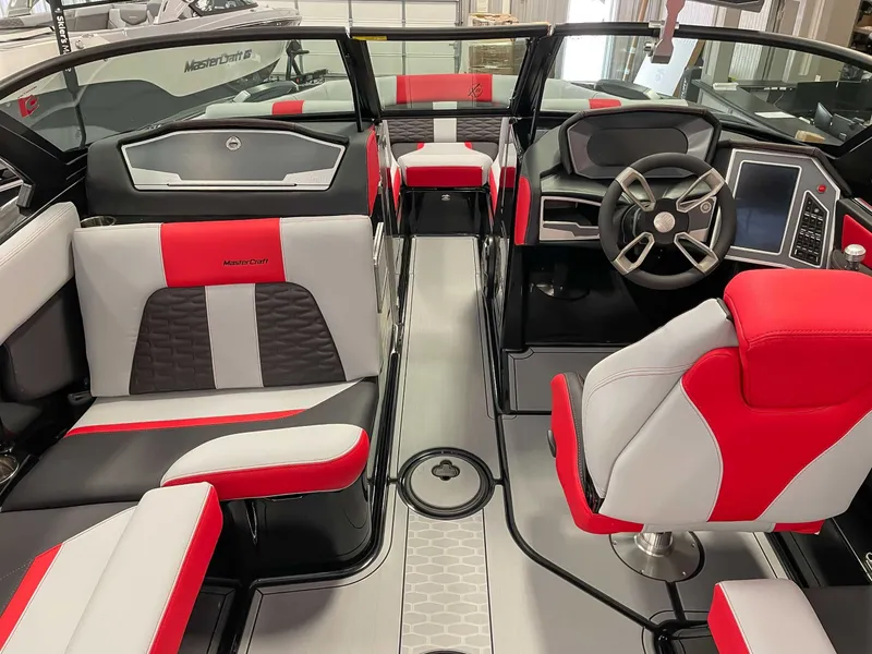 Slide: The Image of Interior of a 2022 MasterCraft X22 boat with red and gray seating. - 10