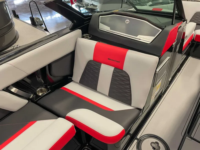 Slide: The Image of Interior of a 2022 MasterCraft X22 boat with red and gray seating. - 15