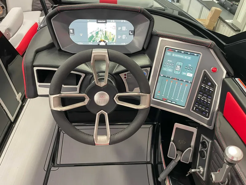 Slide: The Image of MasterCraft X22 2022 boat cockpit with modern steering wheel and touchscreen. - 17