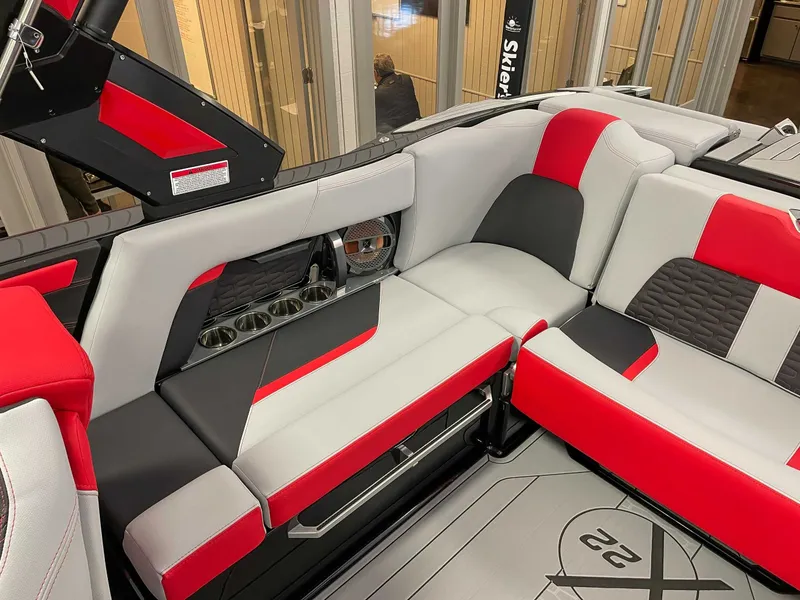 Slide: The Image of Interior of 2022 MasterCraft X22 with red and gray seating. - 19