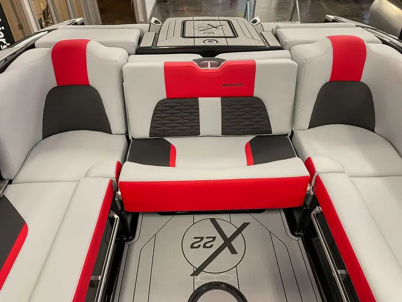 Slide: The Image of Interior of 2022 MasterCraft X22 boat with red and gray seating. - 20