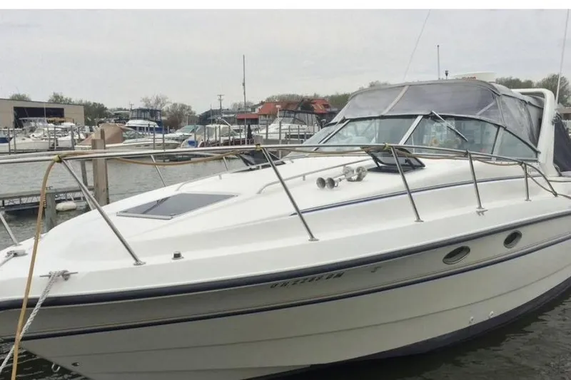 The Image of 1992 Chaparral Signature 30 boat docked at a marina, featuring sleek design and white exterior. - 0
