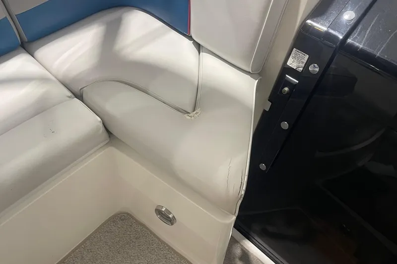 Slide: The Image of 1992 Chaparral Signature 30 boat interior with white and blue seating, showing wear. - 10