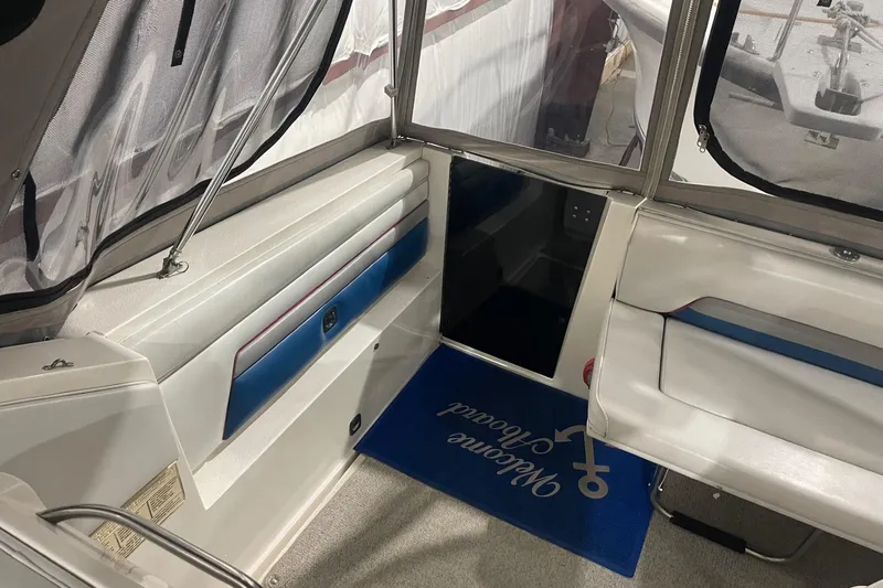 Slide: The Image of Interior of a 1992 Chaparral Signature 30 boat with seating and welcome mat. - 13