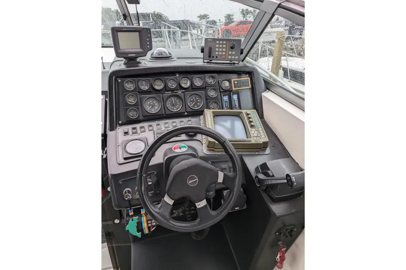 Slide: The Image of 1992 Chaparral Signature 30 boat dashboard with steering wheel and navigation instruments. - 14
