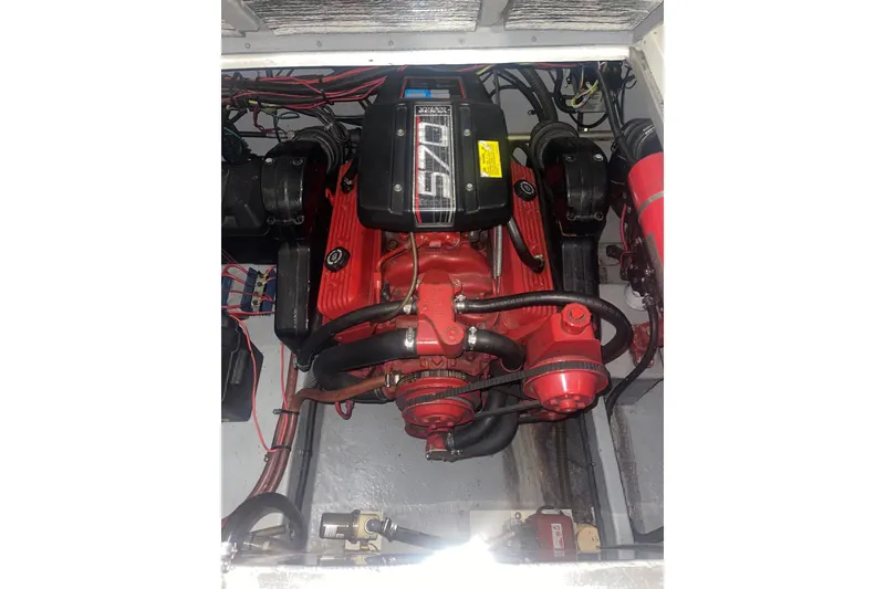 Slide: The Image of Engine compartment of a 1992 Chaparral Signature 30 boat, featuring a red 570 engine. - 15