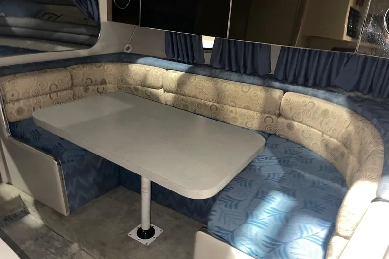 Slide: The Image of Interior of 1992 Chaparral Signature 30 boat with cushioned seating and table. - 21