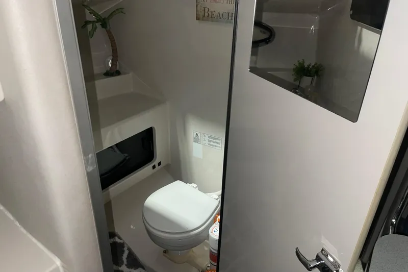 Slide: The Image of 1992 Chaparral Signature 30 boat bathroom interior with toilet and decor. - 25