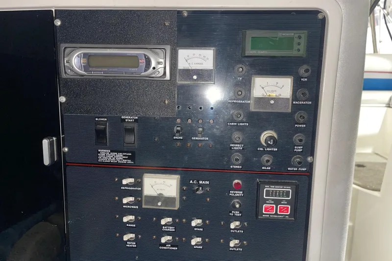 Slide: The Image of Control panel of a 1992 Chaparral Signature 30 boat with various switches and gauges. - 27