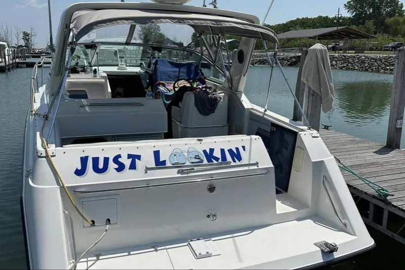 Slide: The Image of 1992 Chaparral Signature 30 boat named "Just Lookin'" docked at a marina. - 3