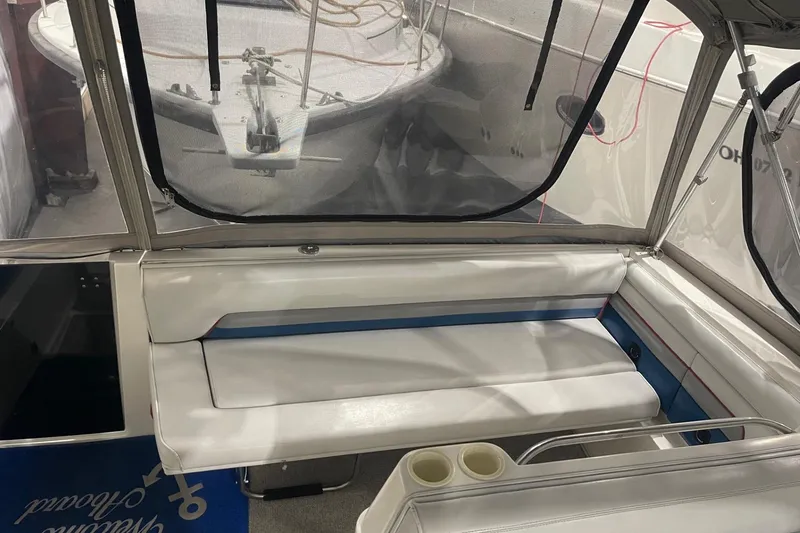 Slide: The Image of 1992 Chaparral Signature 30 boat interior with white seating and clear canopy. - 7