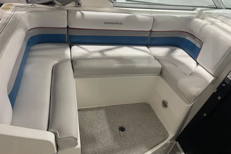 Slide: The Image of 1992 Chaparral Signature 30 boat interior with white and blue cushioned seating. - 9
