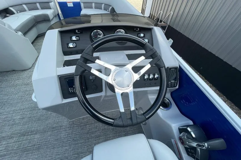 Slide: The Image of 2024 Bennington 23 LSB boat dashboard with steering wheel and controls. - 11