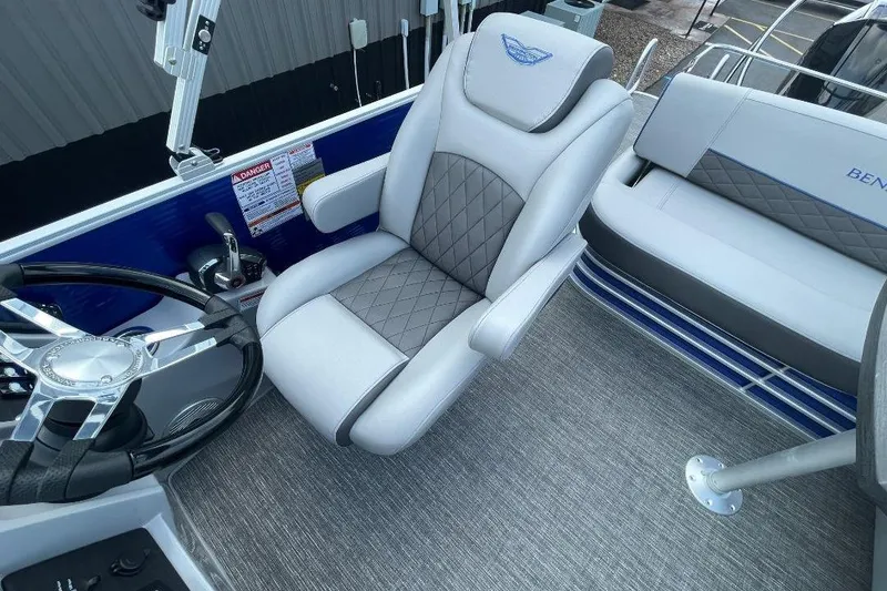 Slide: The Image of 2024 Bennington 23 LSB boat interior with luxury seating and steering wheel. - 12