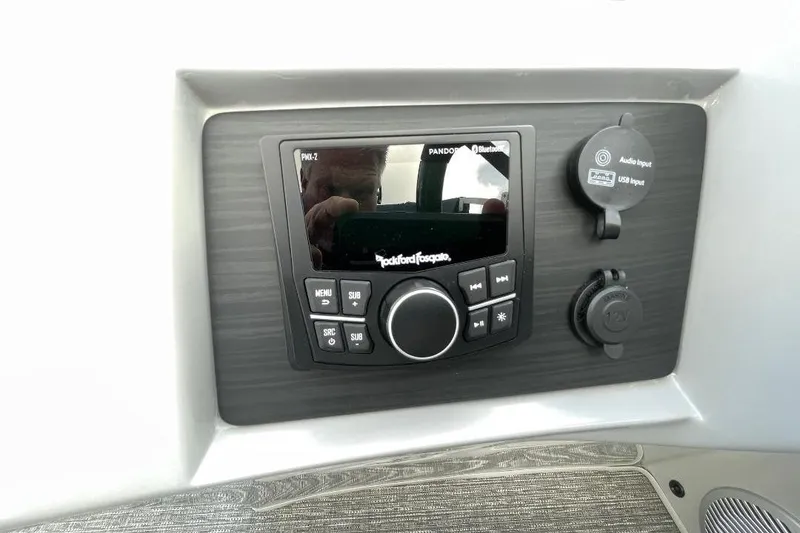 Slide: The Image of 2024 Bennington 23 LSB audio control panel with Rockford Fosgate system and input ports. - 14
