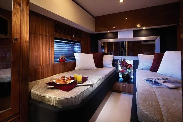 Slide: The Image of Sunseeker Predator 84 yacht, 2010 model, on open water under a partly cloudy sky. - 15