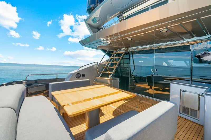 Slide: The Image of Luxurious Sunseeker Predator 84 yacht deck with seating, table, and ocean view, 2010 model. - 18