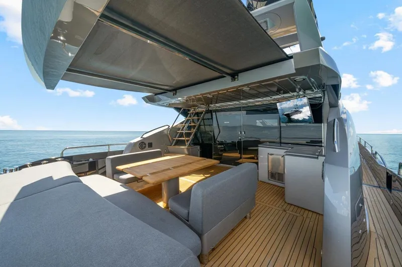 Slide: The Image of Luxurious Sunseeker Predator 84 yacht deck with seating, table, and ocean view, 2010 model. - 20