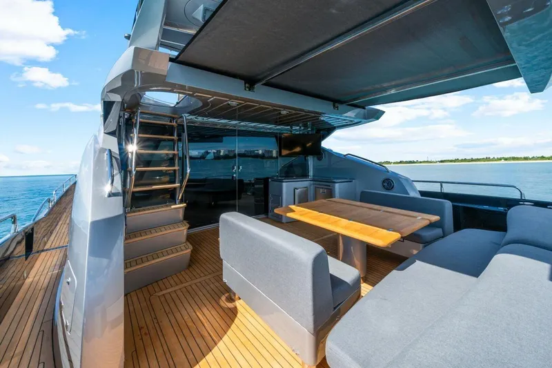 Slide: The Image of Luxurious Sunseeker Predator 84 yacht deck with seating, table, and ocean view, 2010 model. - 21