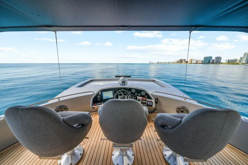 Slide: The Image of Cockpit view of 2010 Sunseeker Predator 84 yacht overlooking calm ocean and distant cityscape. - 27