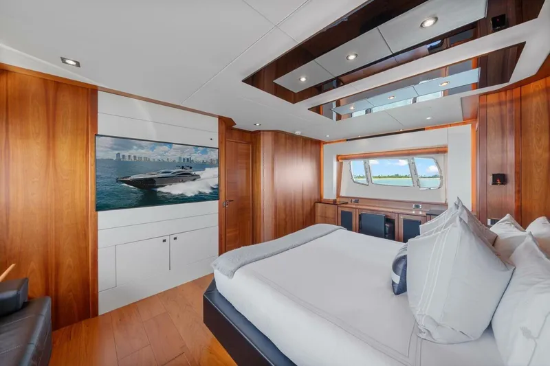 Slide: The Image of Luxurious bedroom interior of 2010 Sunseeker Predator 84 yacht with wood paneling and large window. - 40